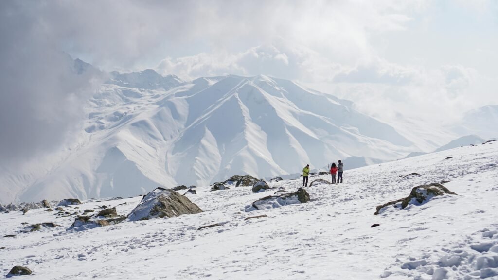 Hikers enjoy a breathtaking winter trek through snow-covered peaks in Kashmir, India.