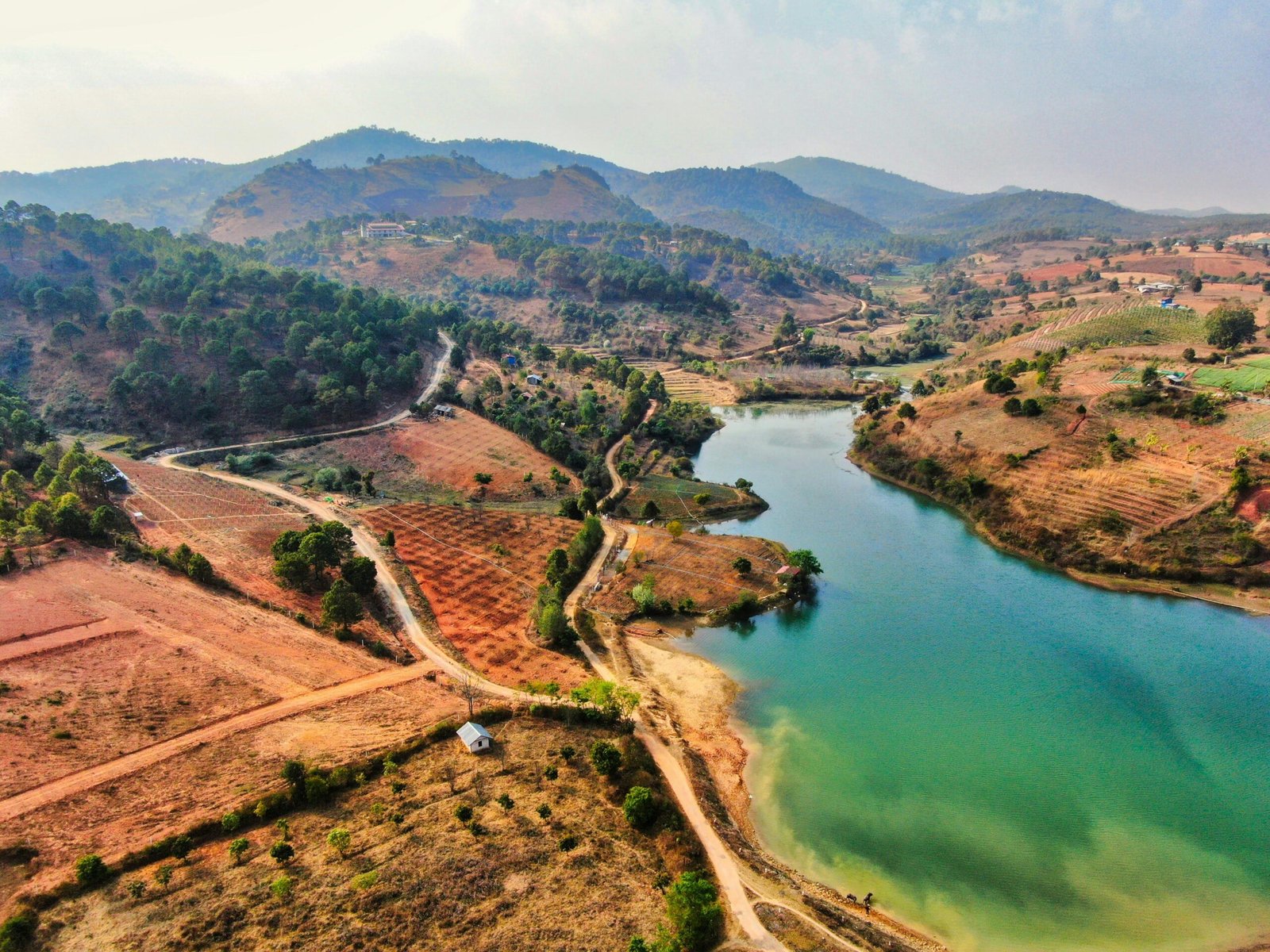 A breathtaking aerial view of the hills and lake in Aungpan, Shan, Myanmar, showcasing lush landscapes.